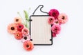 top view of pink flowers and black elegant empty frame over white background. For mock up, copy space Royalty Free Stock Photo
