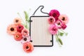 top view of pink flowers and black elegant empty frame over white background. For mock up, copy space Royalty Free Stock Photo