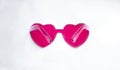 Top view of pink heart shaped sunglasses on light background Royalty Free Stock Photo