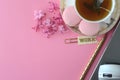 Top view of pink hyacinth, laptop, tea cup, cell phone and French macarons on pink background. Royalty Free Stock Photo