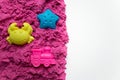 Top view pink kinetic sand with molds. Magic sand for children. Selective focus