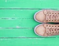 Top view of a pink pair of female leather sneakers