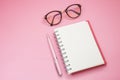 Top view. pen putting beside blank notebook and have glasses on Royalty Free Stock Photo