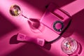 Top view of pink telephone, cocktail and astray with cigarette butts