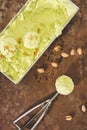 top view of pistachio ice cream with scoop and pistachios