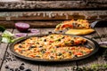 Top view of pizza with bacon and cheese with food ingredients on a wooden board. Raw vegetables on a wooden background. space for Royalty Free Stock Photo