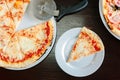 Top view of pizza four cheese, slice and round on table. Royalty Free Stock Photo