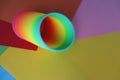 Top view of a plastic toy spring rainbow isolated on the multicolored abstract surface