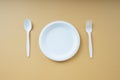 Top view - Plastick plate and spoon and fork. Disposable untensil Royalty Free Stock Photo