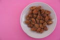 Top view of a plate with caramelized almonds with copy space Royalty Free Stock Photo