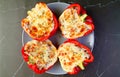 Top View of a Plate of Delectable Stuffed Bell Peppers Isolated on Black Table