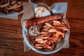 Top view of the plate with delicious fried sausage, french fries and a slice of bread Royalty Free Stock Photo