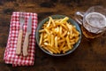 Top view of a plate of french fries with a glass of beer Royalty Free Stock Photo