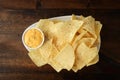 Top view plate of nachos and bowl spicy cheese