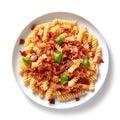 Top view on plate of pasta with bacon.