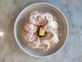 Top view of a plate of puffertjes on a keramic table. Copy space Royalty Free Stock Photo