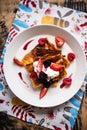 Slices of finnish pancake served with cream and fruits