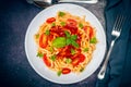 Top view of a plate of spaghetti pasta with a delicious tomato sauce with basil leaves. Natural and homemade food concept Royalty Free Stock Photo