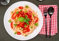 Top view of a plate of spaghetti pasta with a delicious tomato sauce with basil leaves. Natural and homemade food concept Royalty Free Stock Photo