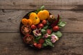 Top view of plate with spinach, garlic, chilli pepper and sliced tomatoes on wooden table. Royalty Free Stock Photo