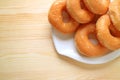 Top View of a Plate of Sugar-glazed Doughnuts on Wooden Table