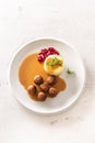 Top view of a plate with Swedish meatballs in sauce with mashed potatoes and cranberry sauce Royalty Free Stock Photo