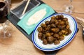 Top view of plate with traditional Spanish tapa Caracoles en salsa - snails stewed to homemade Royalty Free Stock Photo