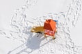 Top view of a playground with colorful slide in park without children and many footprints on snow in winter season