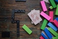 Top view of playing cards, rectangular colorful wooden blocks, and dominoes on the wooden table