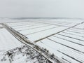 Top view of a plowed field in winter. A field of wheat in the snow