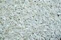 Top view of polished long raw rice background. Organic, natural white rice seed texture
