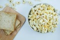 Top view of Popcorn bowl and whole wheat on wooden on a white ba Royalty Free Stock Photo