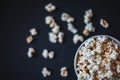 Top view of popcorn in a ceramic bowl on a matte black surface Royalty Free Stock Photo