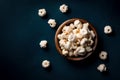 Top view of popcorns in bowl isolated on dark background with copy space