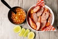 Top view of pork chorizo sausage and a bowl of vegetable soup on a wooden table Royalty Free Stock Photo