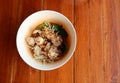 Top view Pork noodles, a popular local Asian food in Thailand, noodles with a wide variety of vegetables on the dining table.