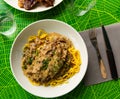 Top view of pork ribs with mushroom sauce and linguine