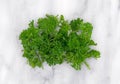 Chopped curly parsley on marble cutting board