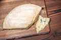 top view of portion fresh blue cheese with mold on wooden texture, dairy product