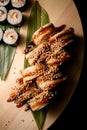 Top view of a portion of philadelphia rolls with eel with sauce and sesame seeds, maki with shrimp filling are next to Royalty Free Stock Photo