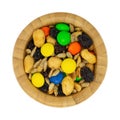 Top view of a portion of sweet and salty trail mix in a wood bowl isolated on a white background Royalty Free Stock Photo