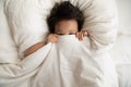 Happy little Asian girl hide under blanket in bed Royalty Free Stock Photo