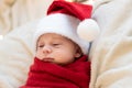 Top View Portrait First Days Of Life Newborn Cute Funny Sleeping Child Baby In Santa Hat Wrapped In Red Diaper At White Royalty Free Stock Photo