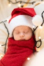 Top View Portrait First Days Of Life Newborn Cute Funny Sleeping Child Baby In Santa Hat Wrapped In Red Diaper At White Royalty Free Stock Photo