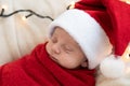 Top View Portrait First Days Of Life Newborn Cute Funny Sleeping Child Baby In Santa Hat Wrapped In Red Diaper At White Royalty Free Stock Photo