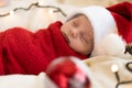 Top View Portrait First Days Of Life Newborn Cute Funny Sleeping Child Baby In Santa Hat Wrapped In Red Diaper At White Royalty Free Stock Photo