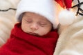 Top View Portrait First Days Of Life Newborn Cute Funny Sleeping Child Baby In Santa Hat Wrapped In Red Diaper At White Royalty Free Stock Photo