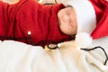 Top View Portrait First Days Of Life Newborn Cute Funny Sleeping Child Baby In Santa Hat Wrapped In Red Diaper At White Royalty Free Stock Photo