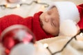 Top View Portrait First Days Of Life Newborn Cute Funny Sleeping Child Baby In Santa Hat Wrapped In Red Diaper At White Royalty Free Stock Photo