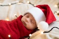 Top View Portrait First Days Of Life Newborn Cute Funny Sleeping Child Baby In Santa Hat Wrapped In Red Diaper At White Royalty Free Stock Photo